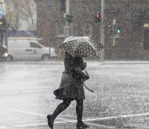 City commuters are seen through heavy rain, in Sydney, Tuesday, June 19, 2018. The Bureau of Meteorology have issued a severe weather warning for parts of the Hunter, Central Coast and Sydney, which in turn brought about a hazardous surf warning for the area as well. (AAP Image/Chris Pavlich) NO ARCHIVING