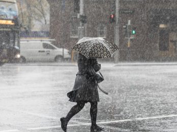 City commuters are seen through heavy rain, in Sydney, Tuesday, June 19, 2018. The Bureau of Meteorology have issued a severe weather warning for parts of the Hunter, Central Coast and Sydney, which in turn brought about a hazardous surf warning for the area as well. (AAP Image/Chris Pavlich) NO ARCHIVING